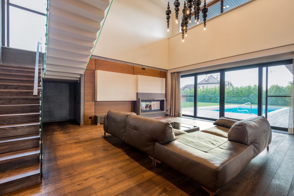 A clean, modern living room with a large window showing a clear, beautiful view of the Aspen mountains, symbolizing clarity in real estate.
